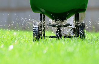 fertilizer moving through green lawn